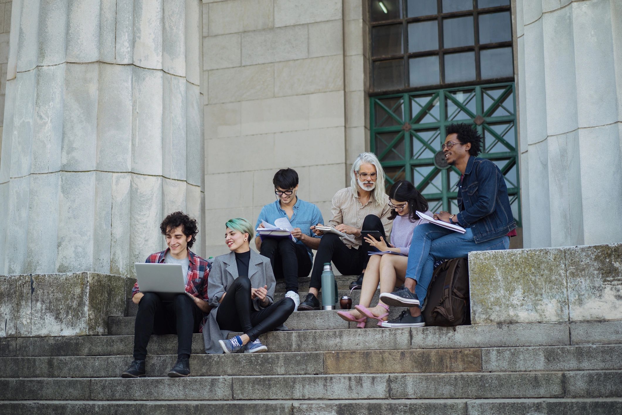 Group of college students learning together outdoors