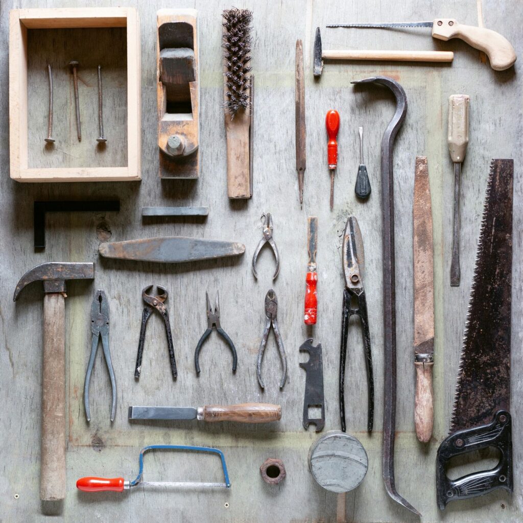 Various hand tools arranged on wood. Flat lay.