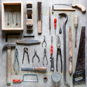 Various hand tools arranged on wood. Flat lay.