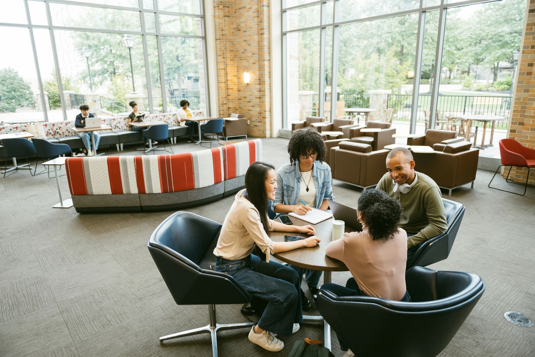 Students collaborating around a table on campus