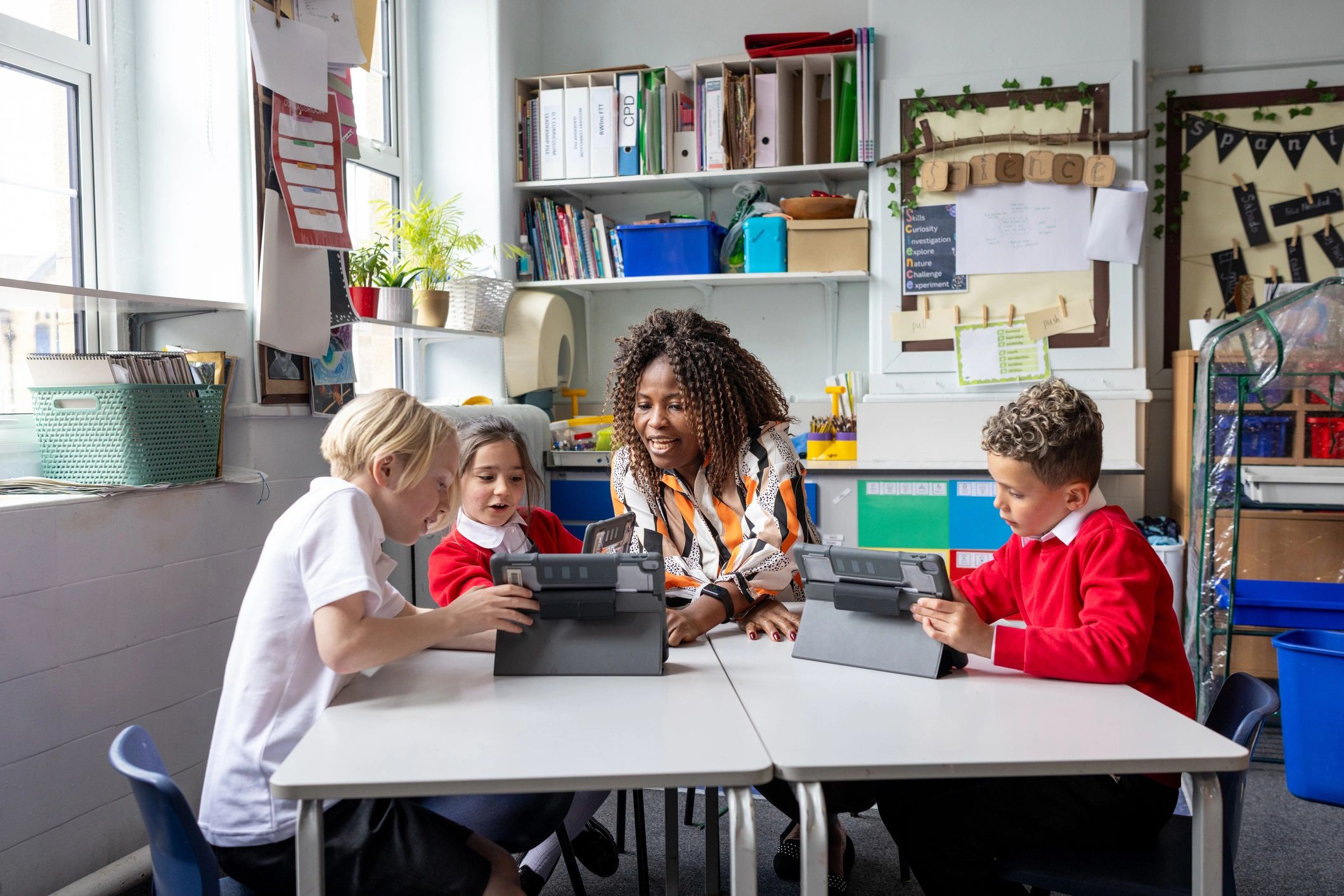 Students and teacher using school supplies in class