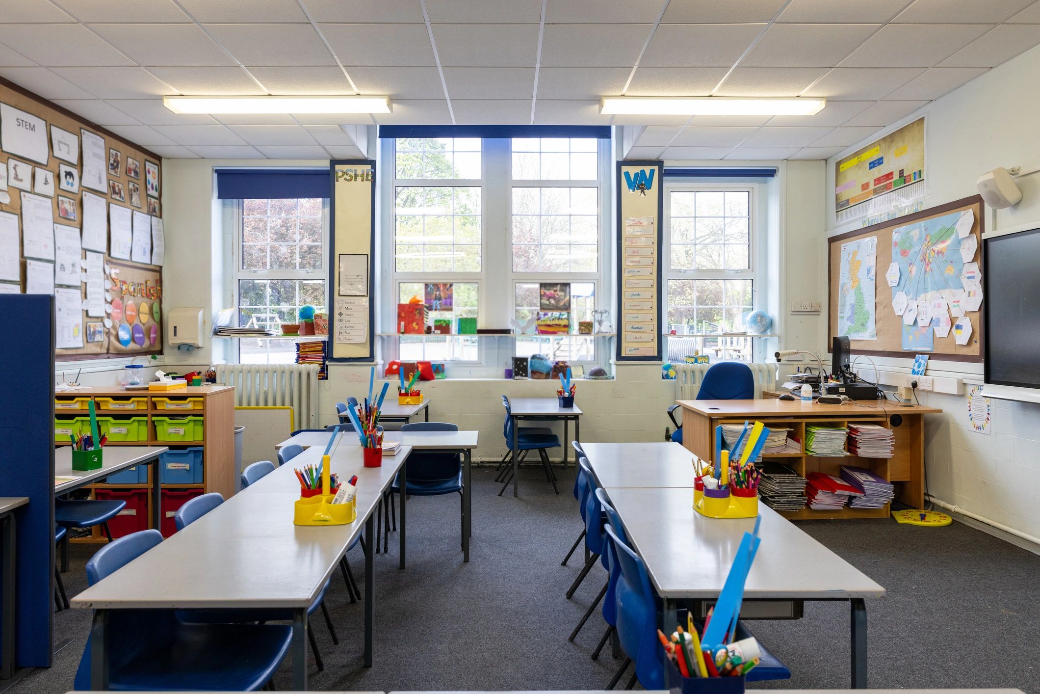 Classroom ready for learning with organized desks and school supplies
