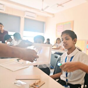 Teacher demonstrating light-up STEM project to students