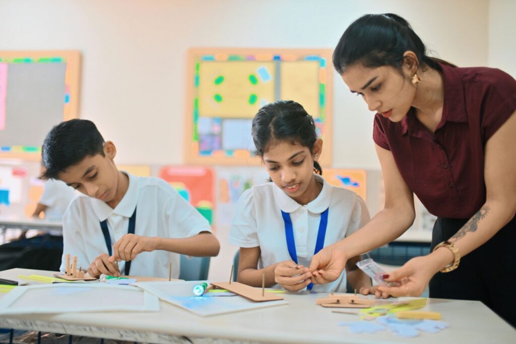 Teacher guiding students in STEM classroom activity