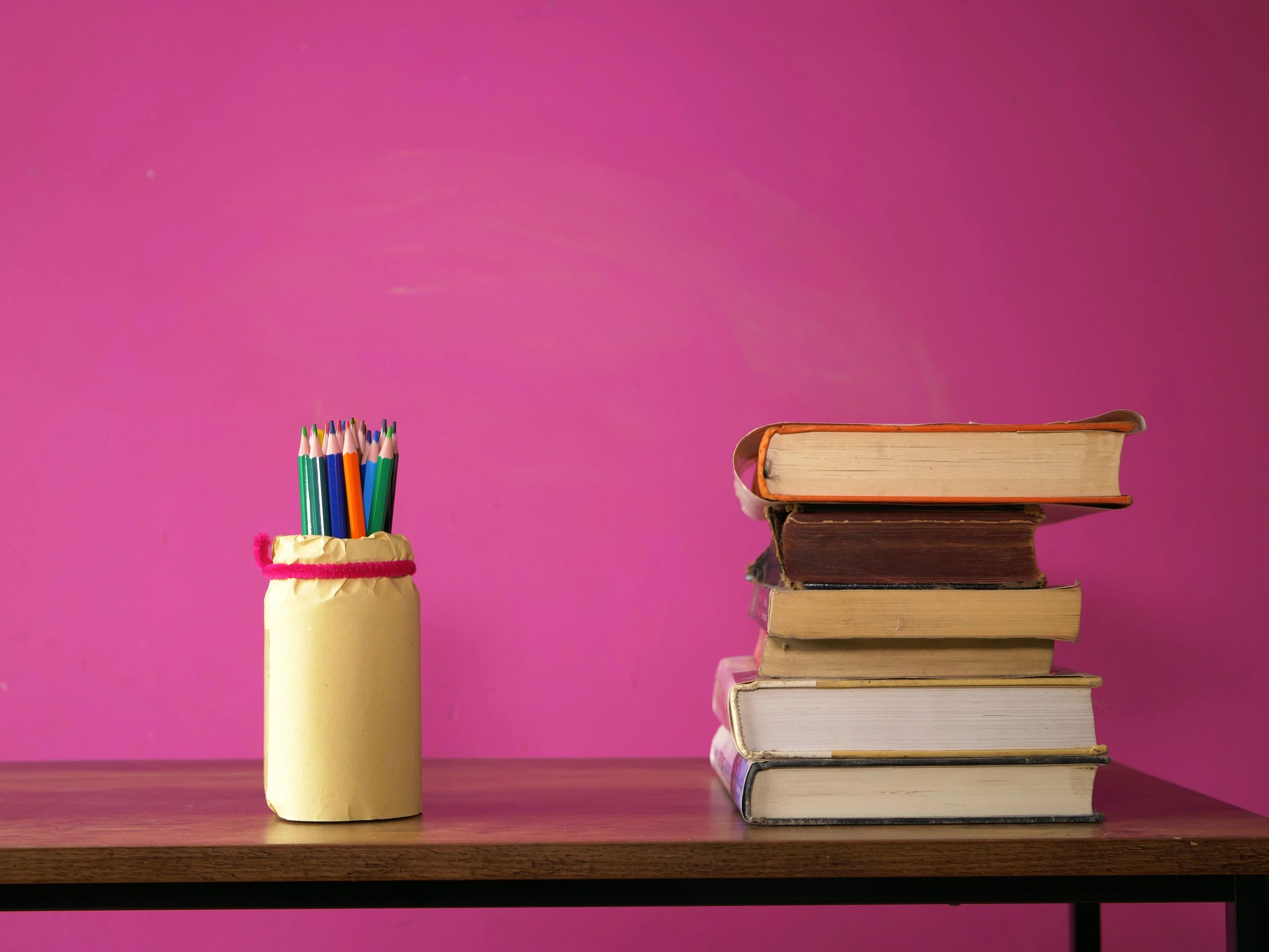 Books and pencils arranged on a teacher desk