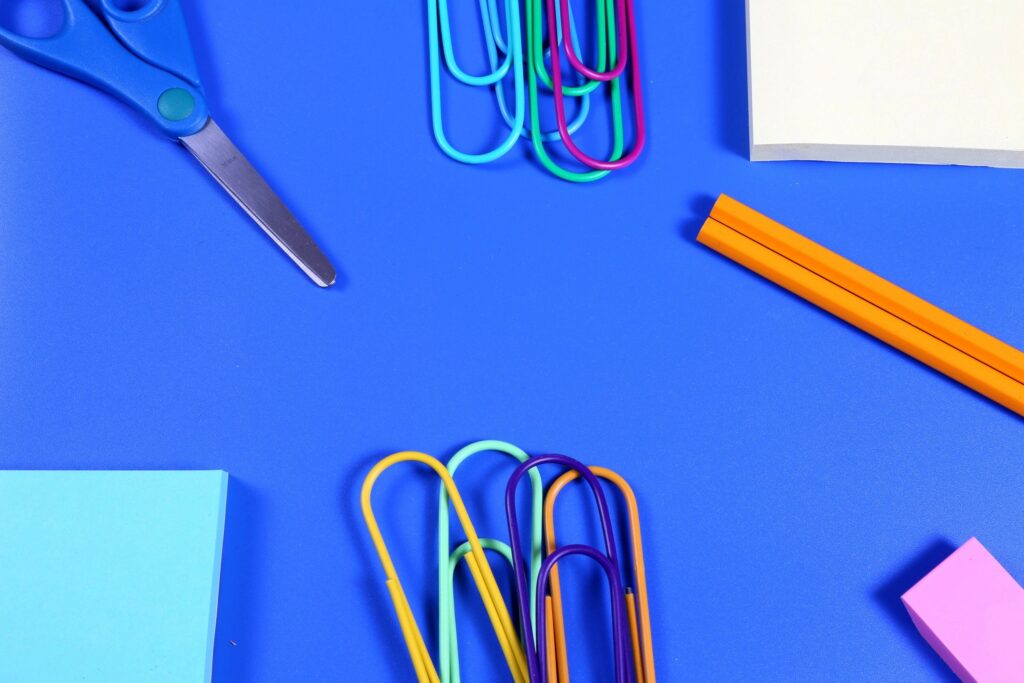 School Supplies on blue background with copy space