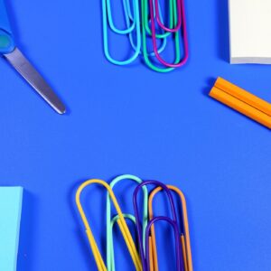 School Supplies on blue background with copy space