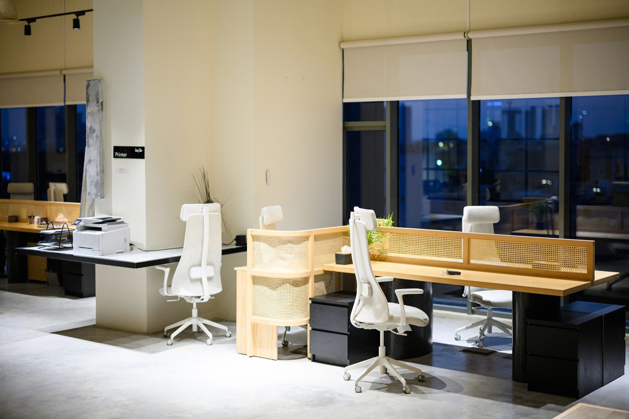 Modern office workspace with desks and seating for business customers