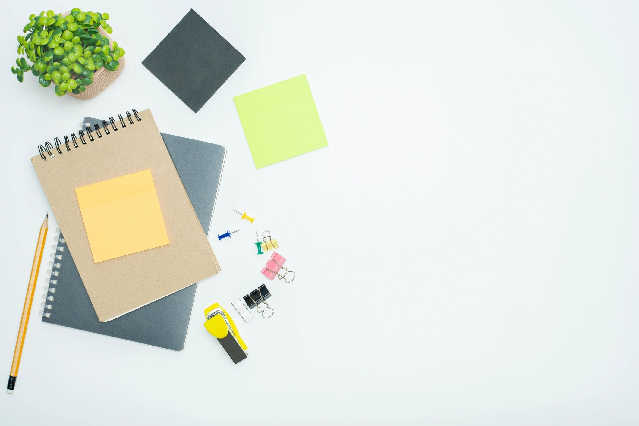 Office and school stationery supplies arranged neatly on a white background